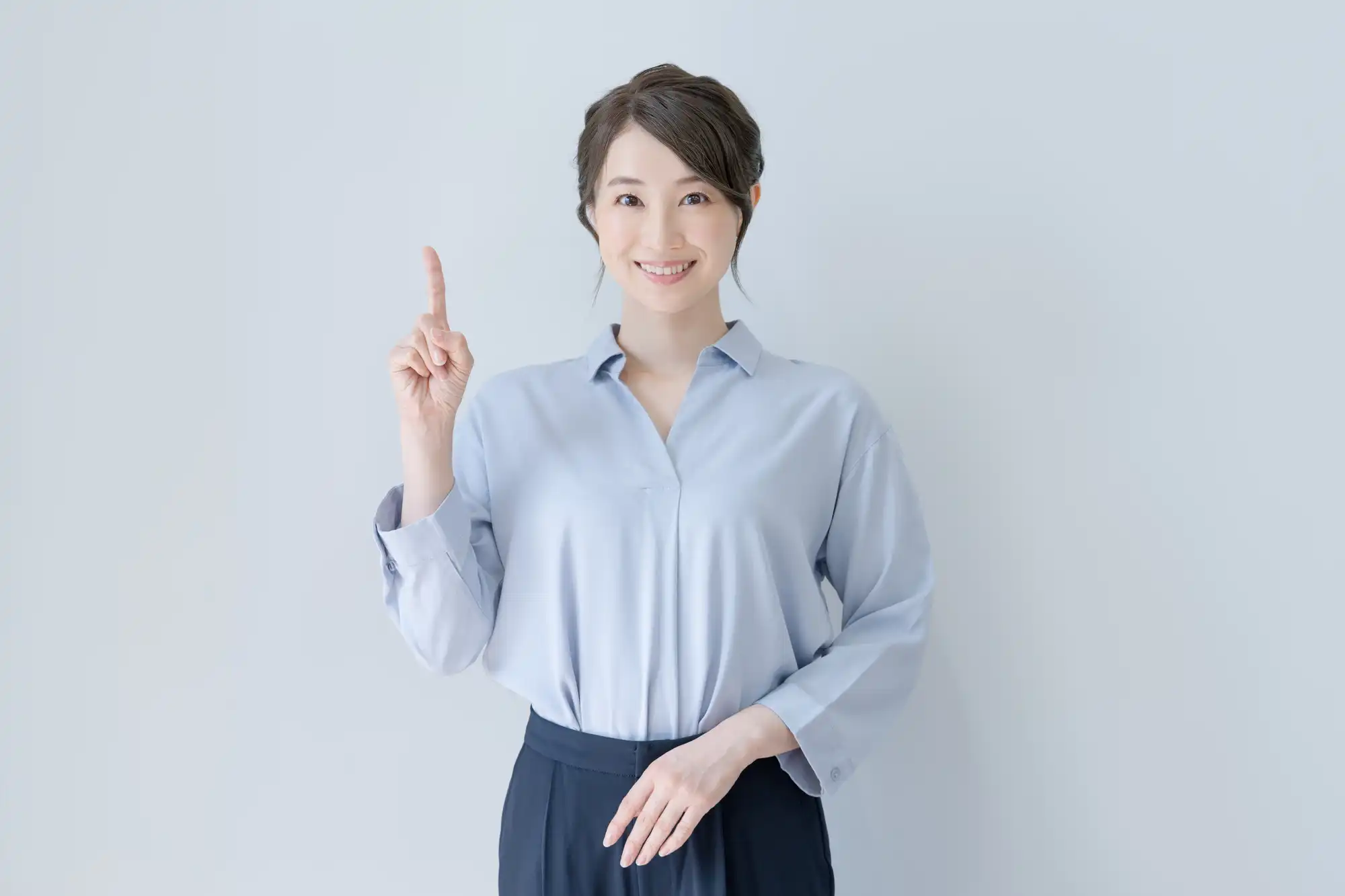 人差し指を立てている女性